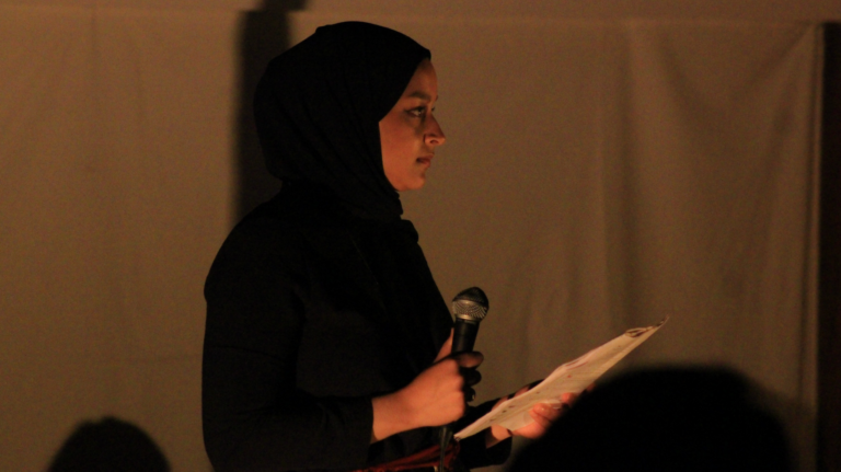 Saman Dara of stitched! performs "Letter from Battir" Photo: Amber Ranson